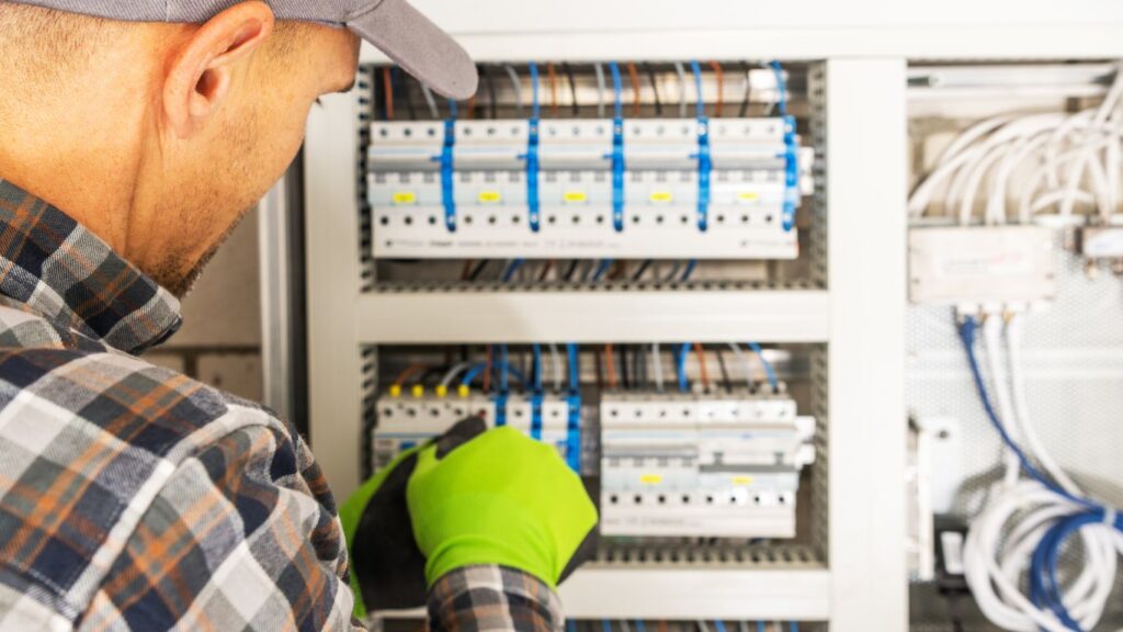 Expert electrician repairing electrical panel
