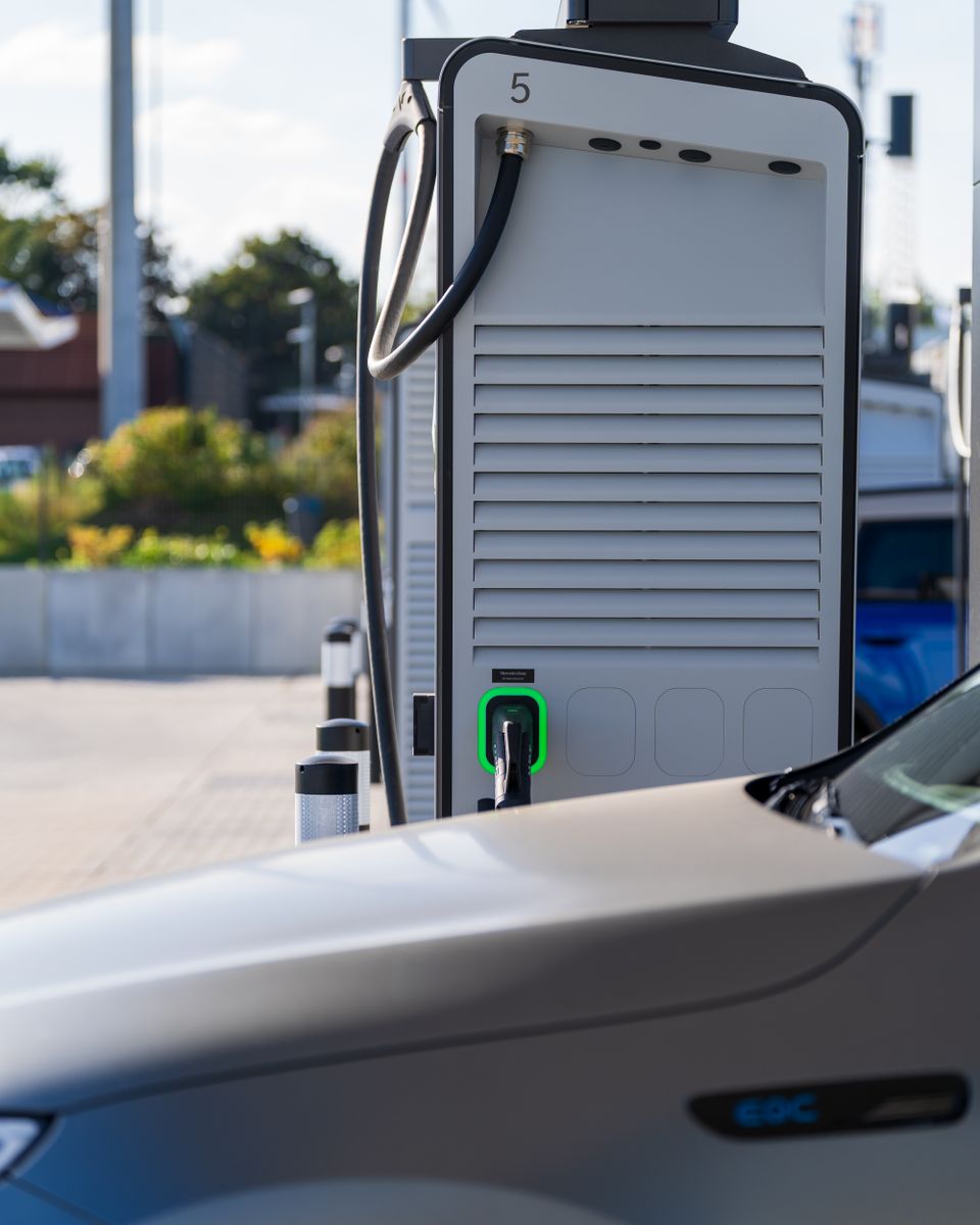 Electric car charging at a modern outdoor station, showcasing eco-friendly technology.