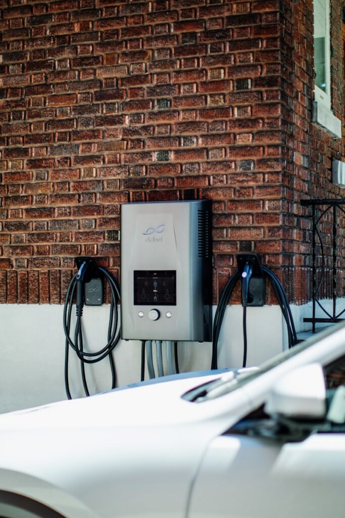 Electric car charging station mounted on brick wall