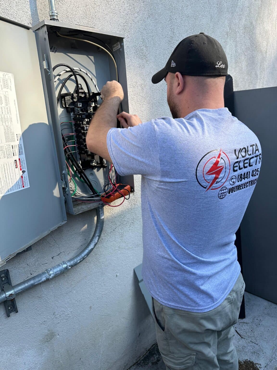 Volta Electric electrician working on an electrical panel