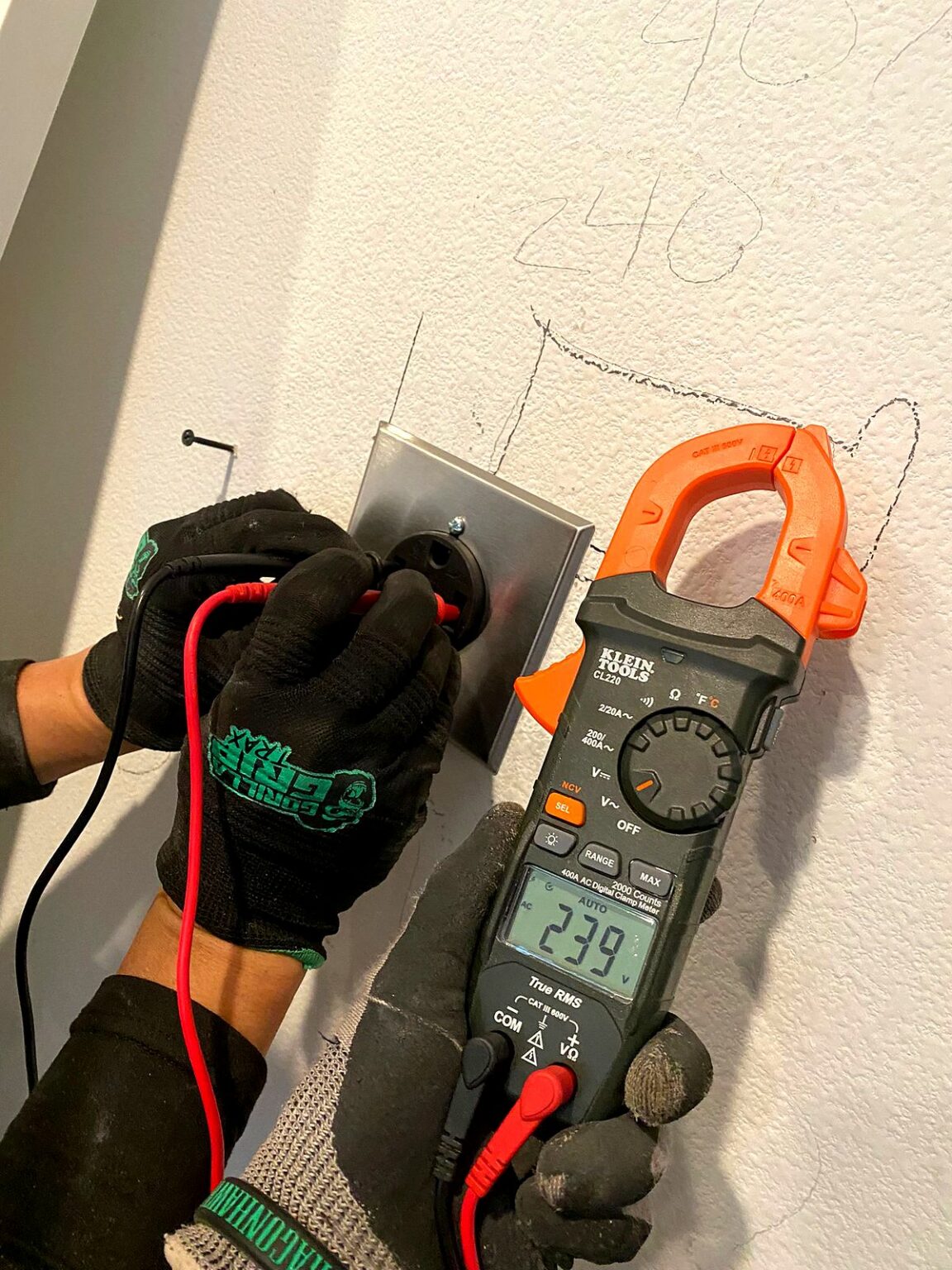 Volta Electric electrician testing a circuit with a clamp meter while troubleshooting