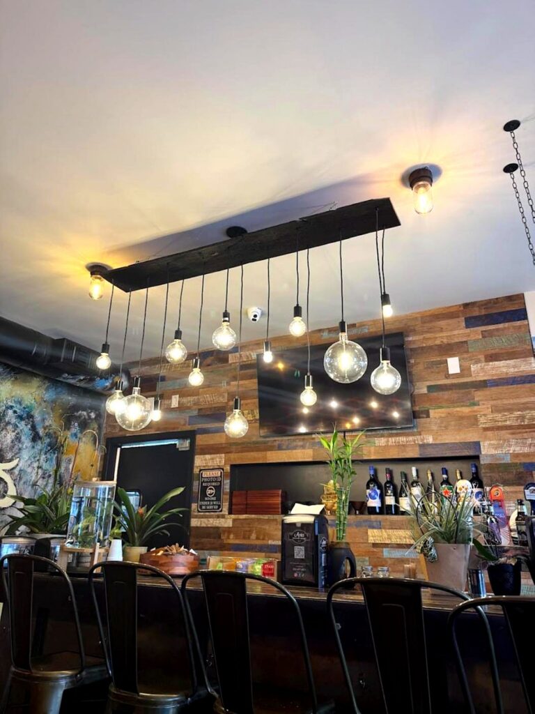 Pendant lights over a restaurant bar installed by Volta Electric