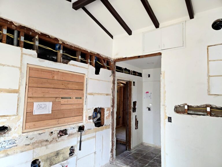 Kitchen wall opened along the top and at the boxes for a Volta rewire