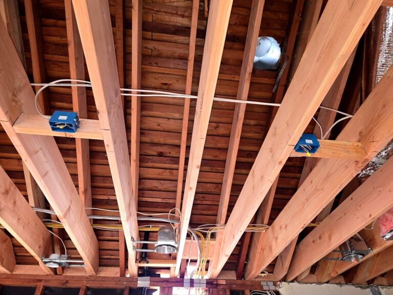 New ceiling boxes and cable between open ceiling joists during a Volta rewire
