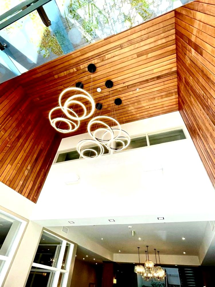Ring chandelier on a high ceiling installed by Volta Electric