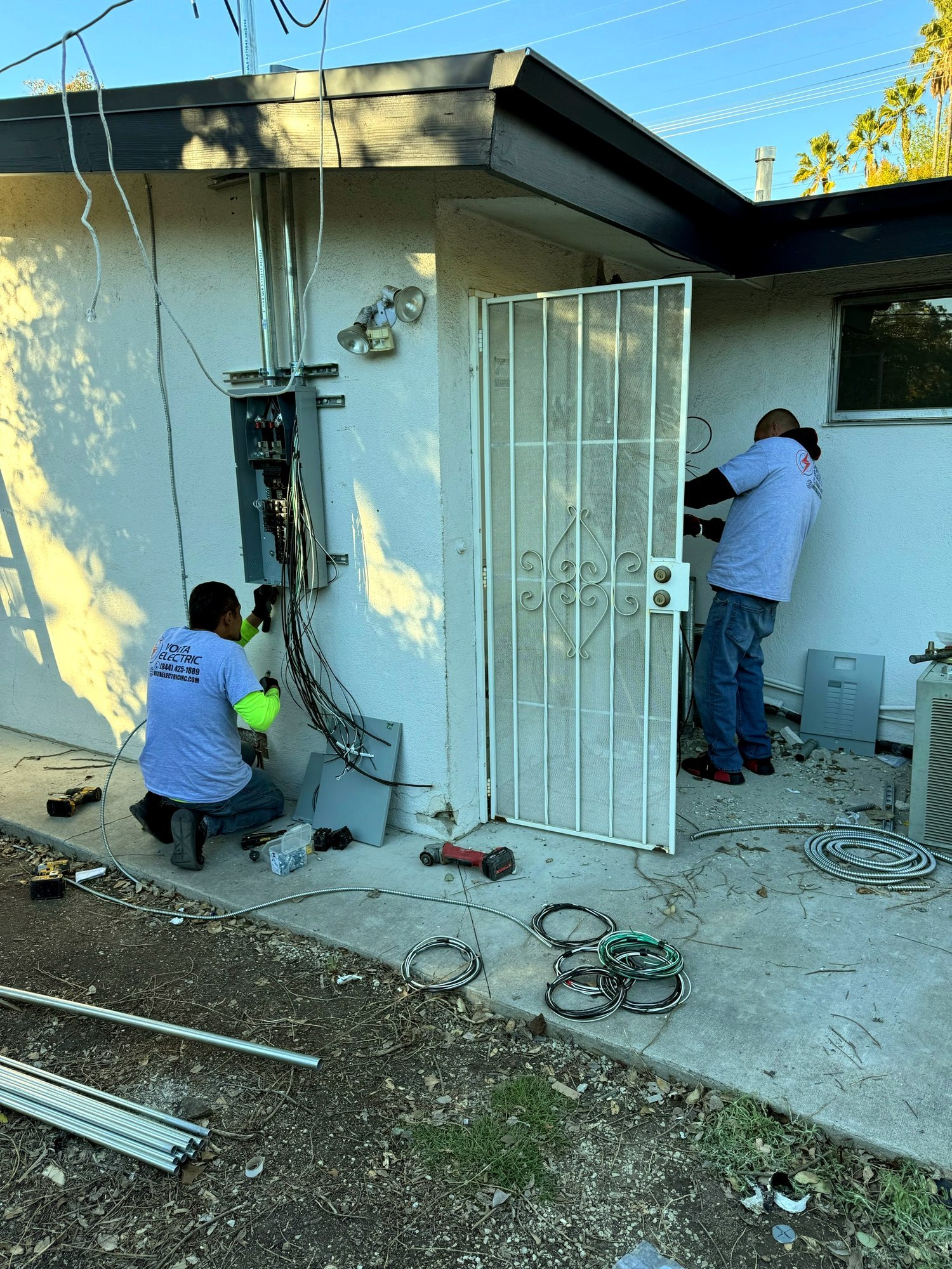 Volta Electric technician completing a panel upgrade near a home entryway