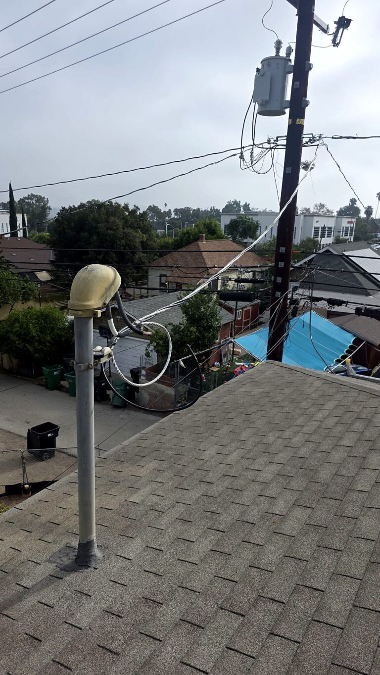 Service mast and weatherhead at the utility connection, installed by Volta Electric